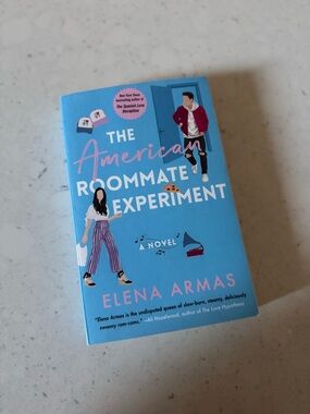 The American Roommate Experiment by Elena Armas - Bright Blue Paperback book